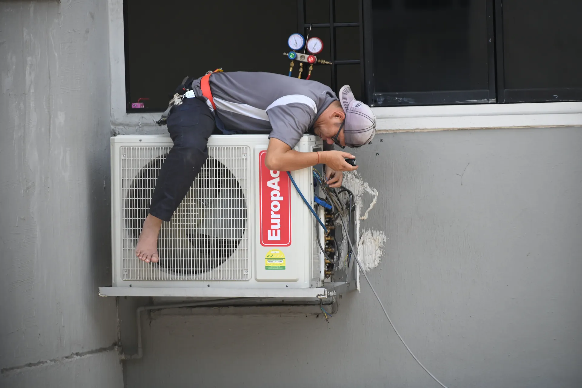 Técnico da Única Climatização instalando ar-condicionado em Nilópolis